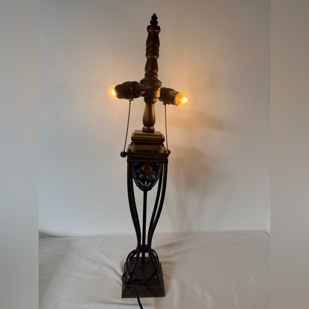 Mission style metal table lamp base with floral stained glass accent panel.